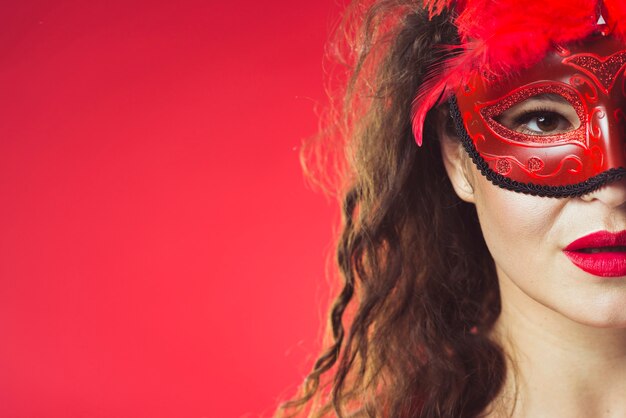 Woman posing in red mask