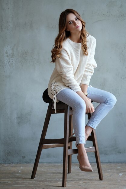 Woman posing sitting on a chair