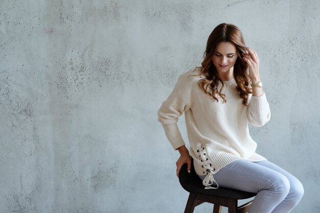 Woman posing sitting on a chair