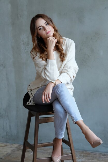 Woman posing sitting on a chair