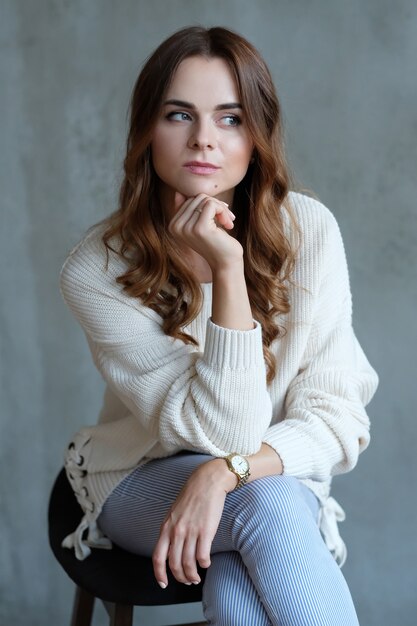 Woman posing sitting on a chair