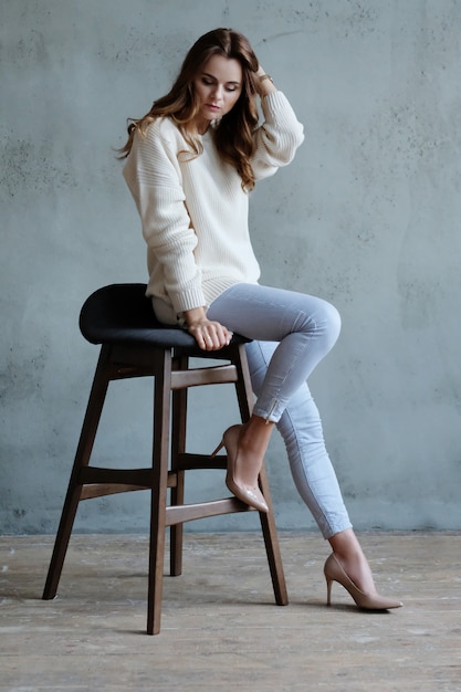 Woman posing sitting on a chair