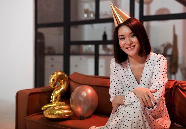 Woman posing on the sofa at new year's eve party with copy space