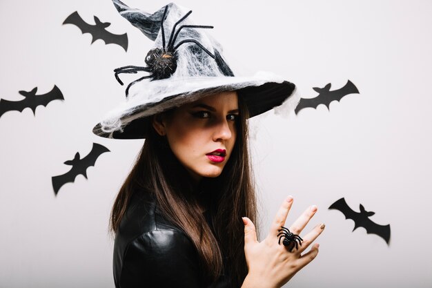 Woman posing in spooky spider hat