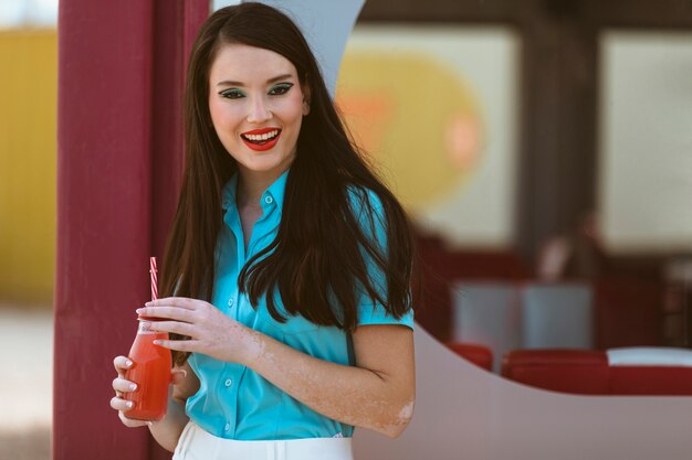 Woman posing together in retro style with beverage