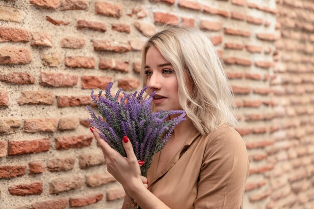 woman posing while holding bouquet of lavender