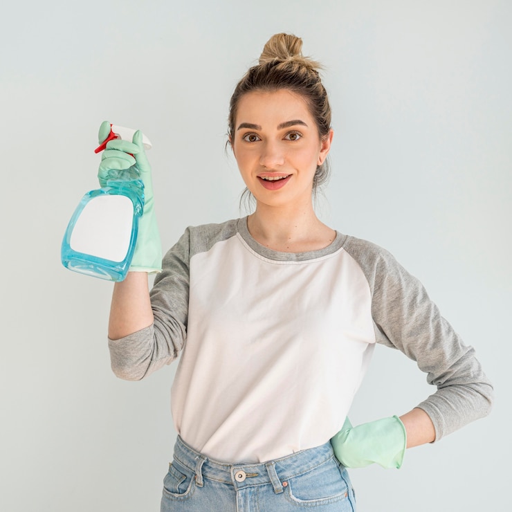 Free Photo woman posing while holding cleaning solution