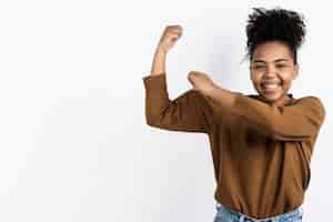 Free photo woman posing while showing bicep