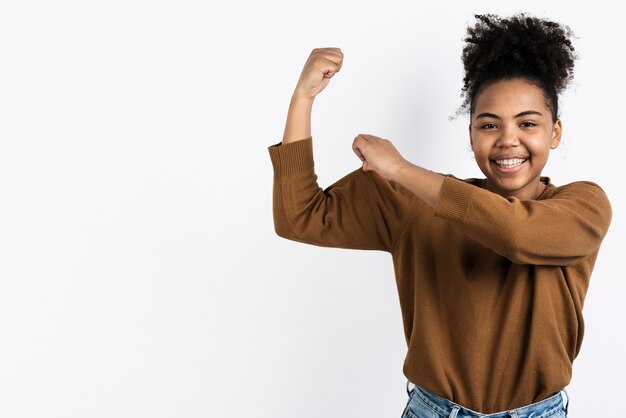 Woman posing while showing bicep