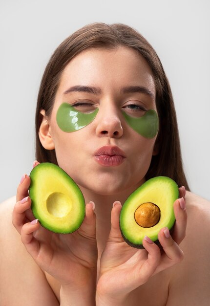 Woman posing with avocado front view