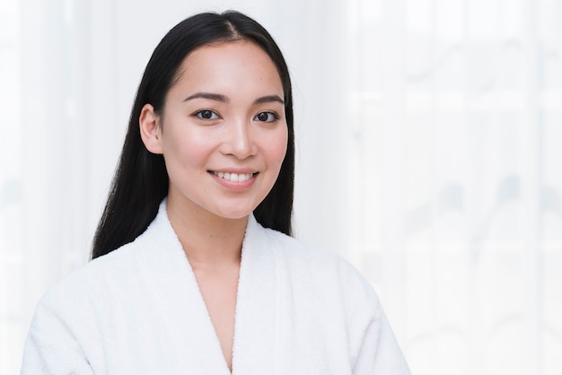 Woman posing with bathrobe in a spa