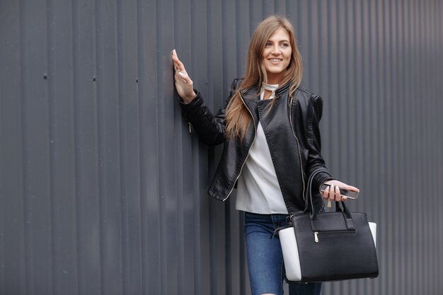 Woman posing with a black and white bag