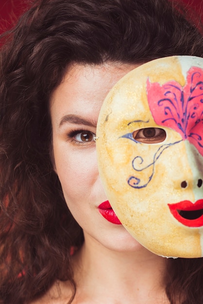 Free photo woman posing with bright mask