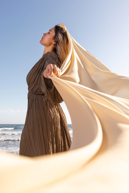 Free photo woman posing with cloth medium shot