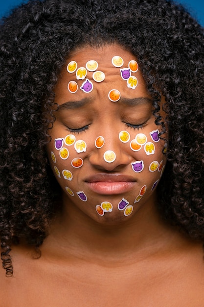 Foto gratuita donna in posa con emoji sulla vista frontale del viso