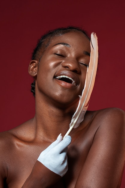 Free photo woman posing with feather front view