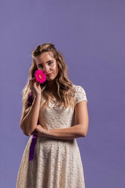 Woman posing with flower and copy space