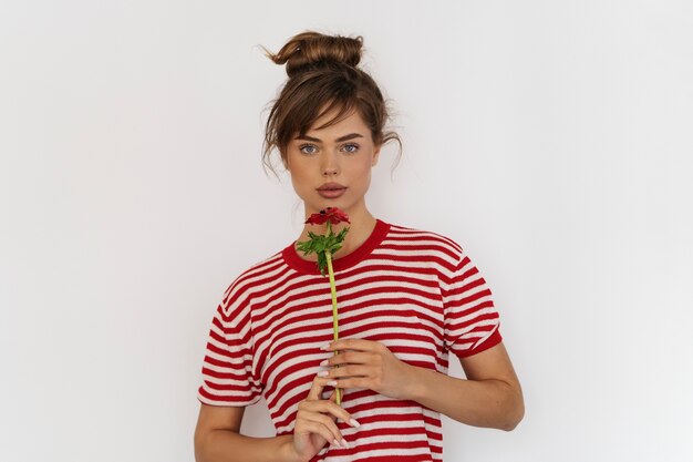 Woman posing with flower front view