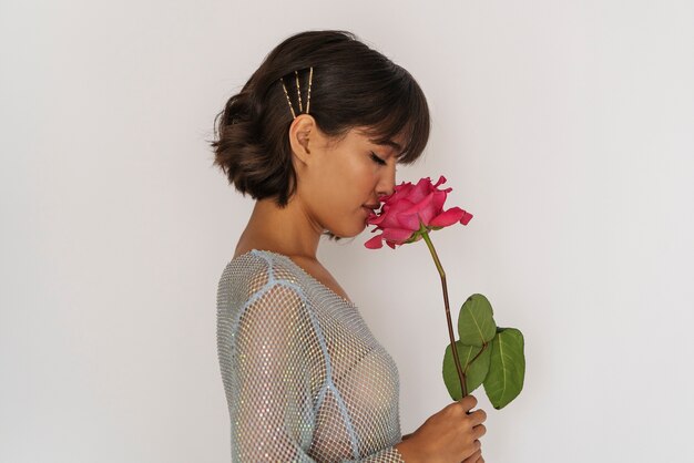 Woman posing with flower side view