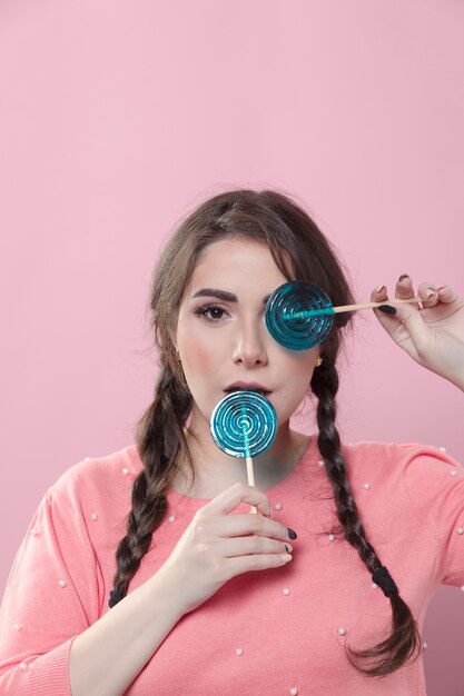 Woman posing with lollipops and copy space