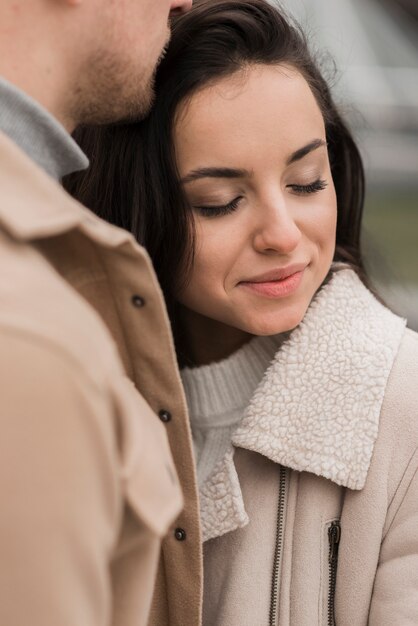 Woman posing with man outdoors