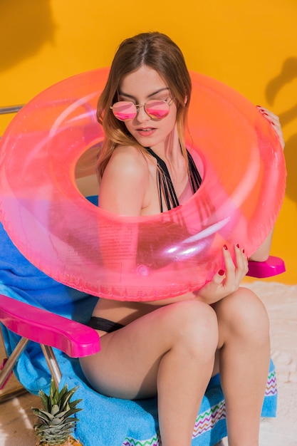 Free photo woman posing with pink lifesaver