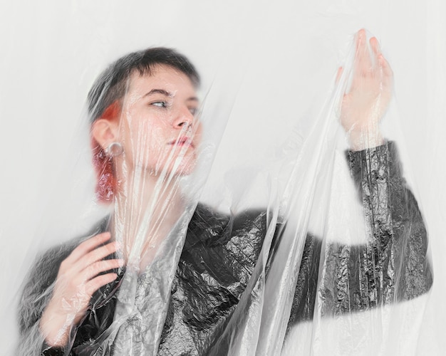 Free photo woman posing with plastic foil