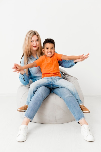 Woman posing with smiley boy