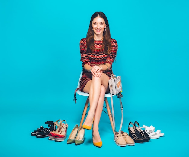 Woman posing with stylish footwear summer fashion and bag, long legs, shopping