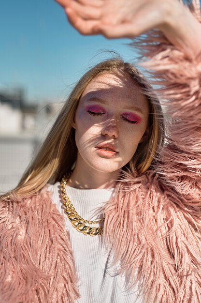 Woman posing with sunglasses front view