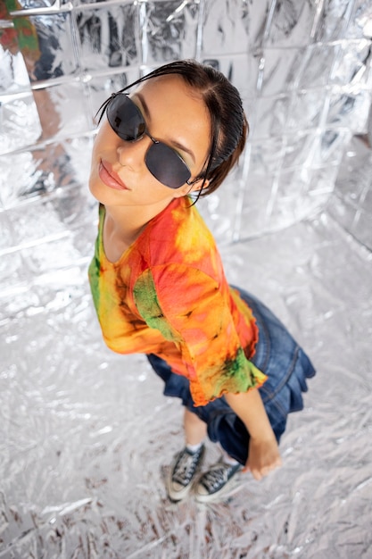 Woman posing with sunglasses high angle