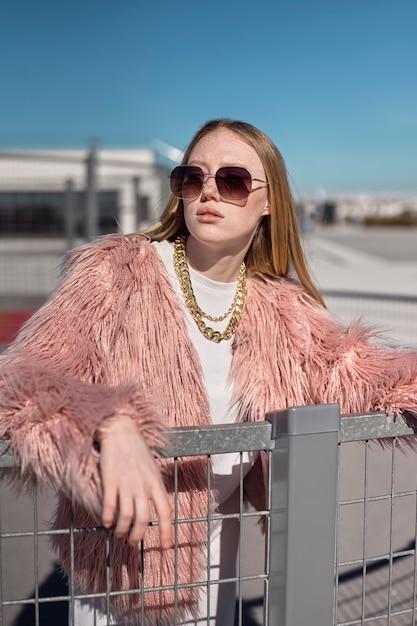 Woman posing with sunglasses medium shot