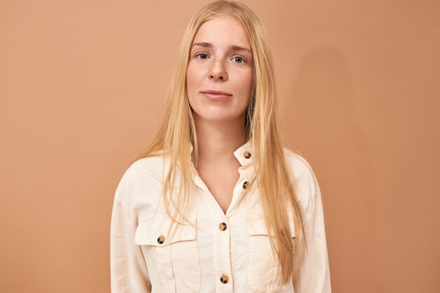 woman posing with white shirt on beige