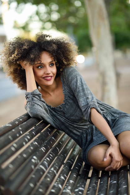 Free photo woman posing on a wooden bench