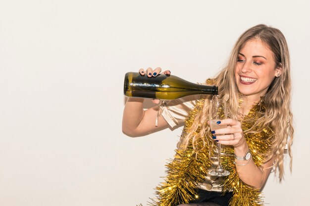 Woman pouring champagne in glass 