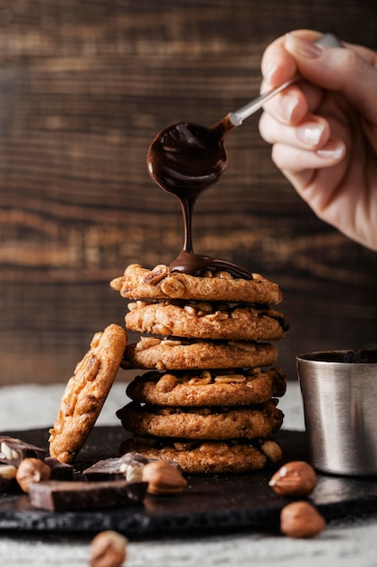 woman pouring chocolate on Delicious cookies