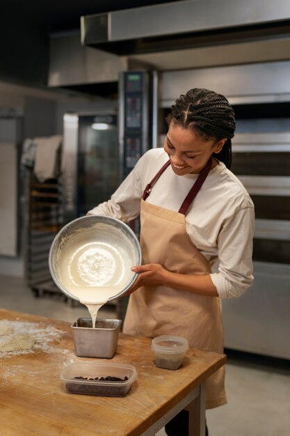 Woman pouring dough medium shot