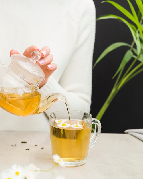 Woman pouring tea from crystal teapot