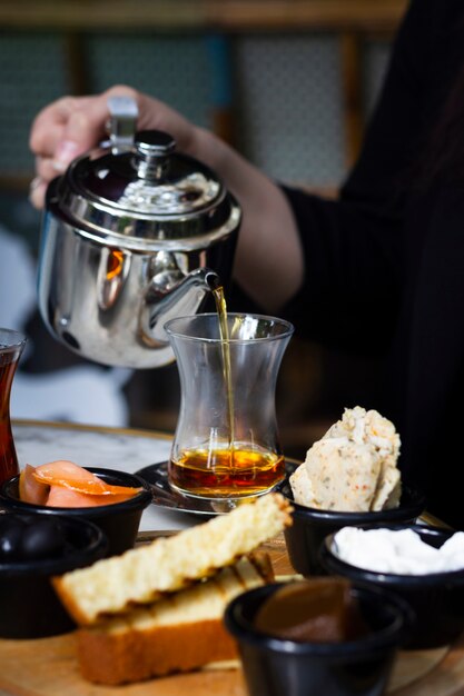 Woman pouring tea in glass