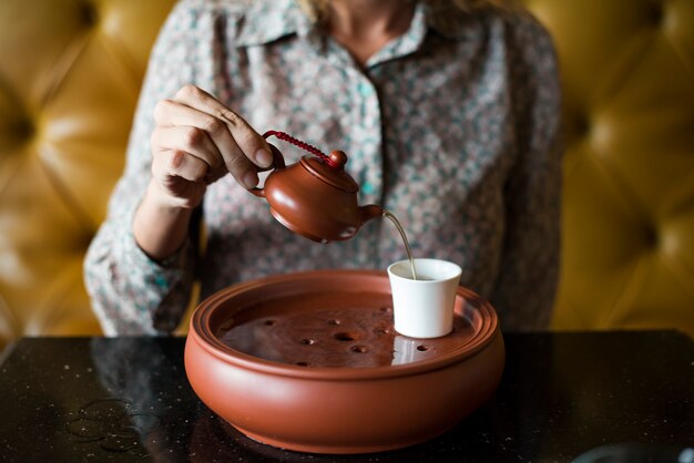 Woman pouring tea into a cup