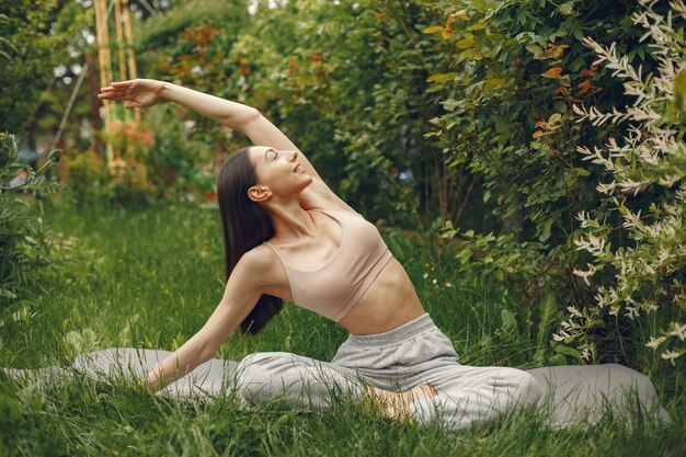 Woman practicing advanced yoga in a park