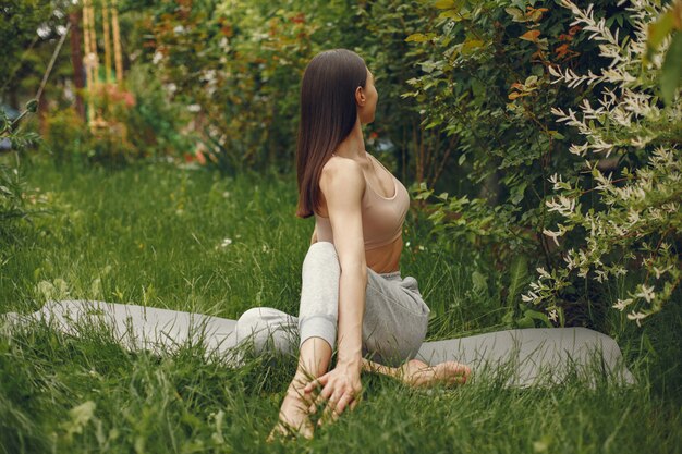 Woman practicing advanced yoga in a park