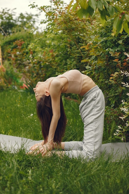 Woman practicing advanced yoga in a park