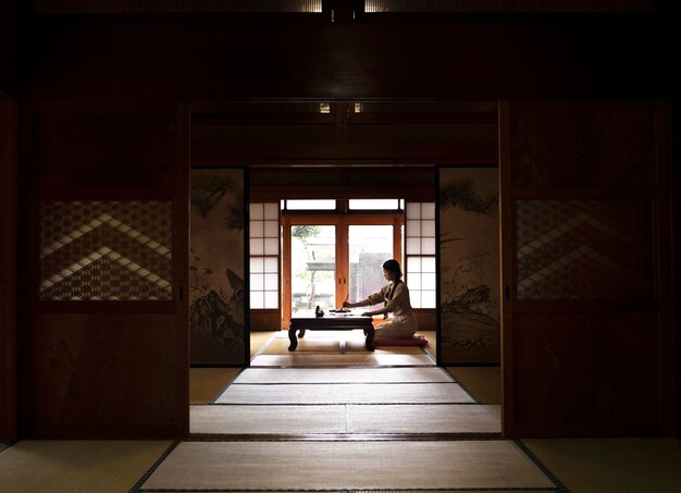 Woman practicing japanese handwriting at home