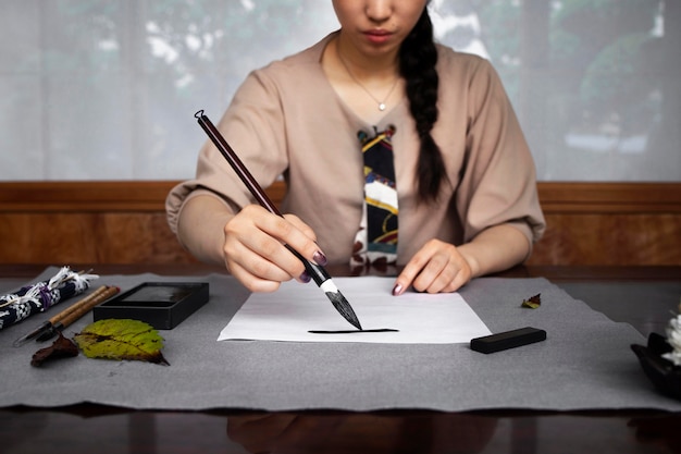 Free photo woman practicing japanese handwriting