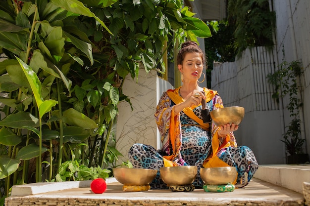 Woman practicing with singing bowls