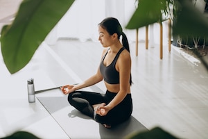 Woman practicing yoga on mat at home