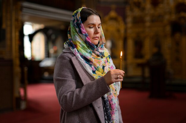 Woman praying in church for religious pilgrimage