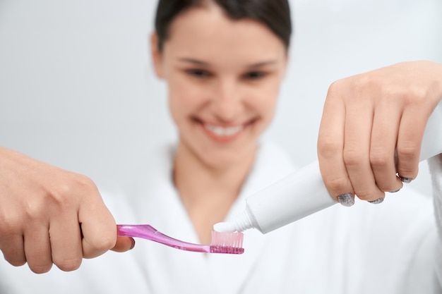 Woman preparing for cleaning teeth at home