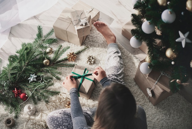 Woman preparing a gift on floor